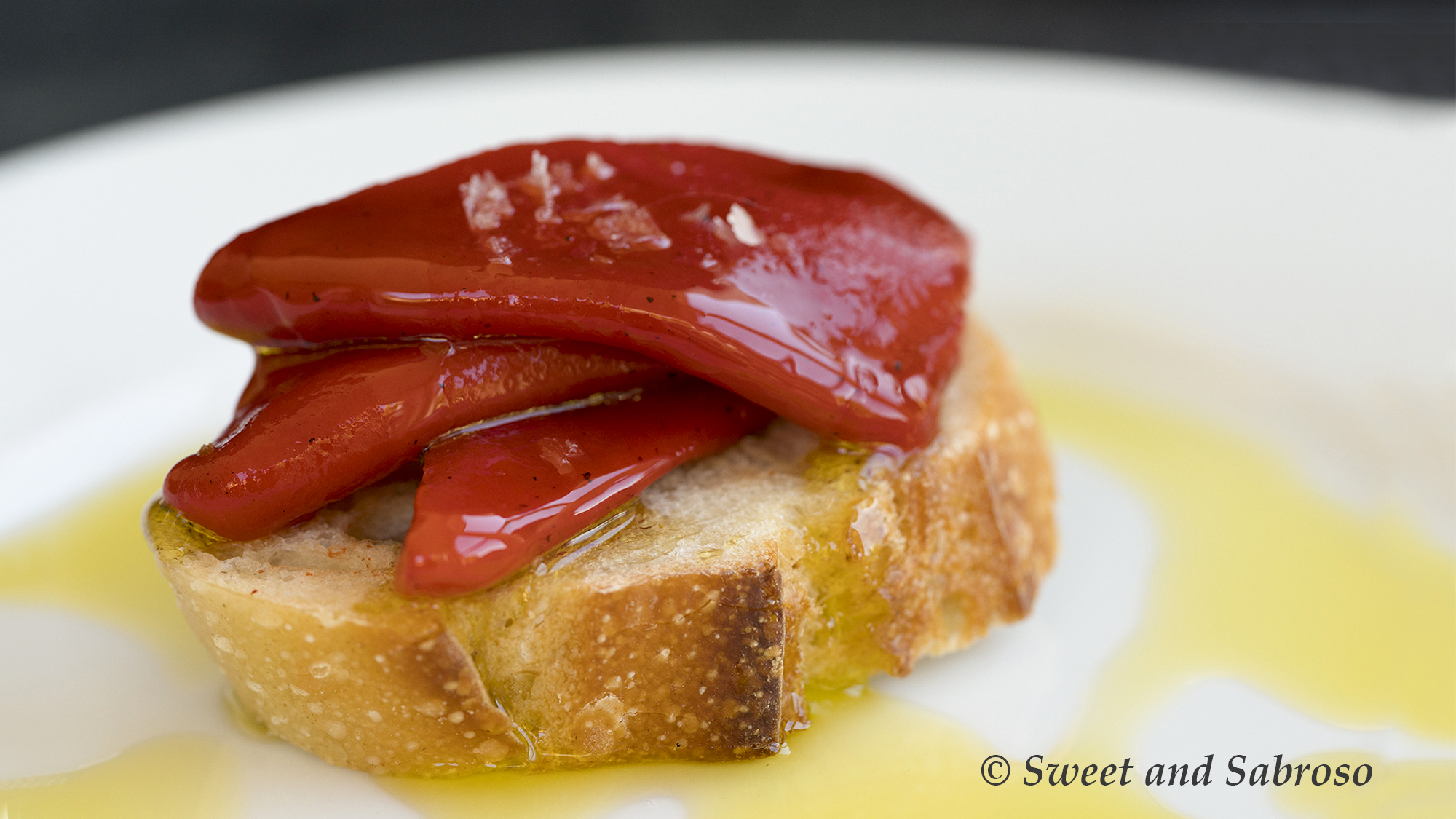 Piquillo Peppers from Spain on a slice of crusty bread with salt and olive oil