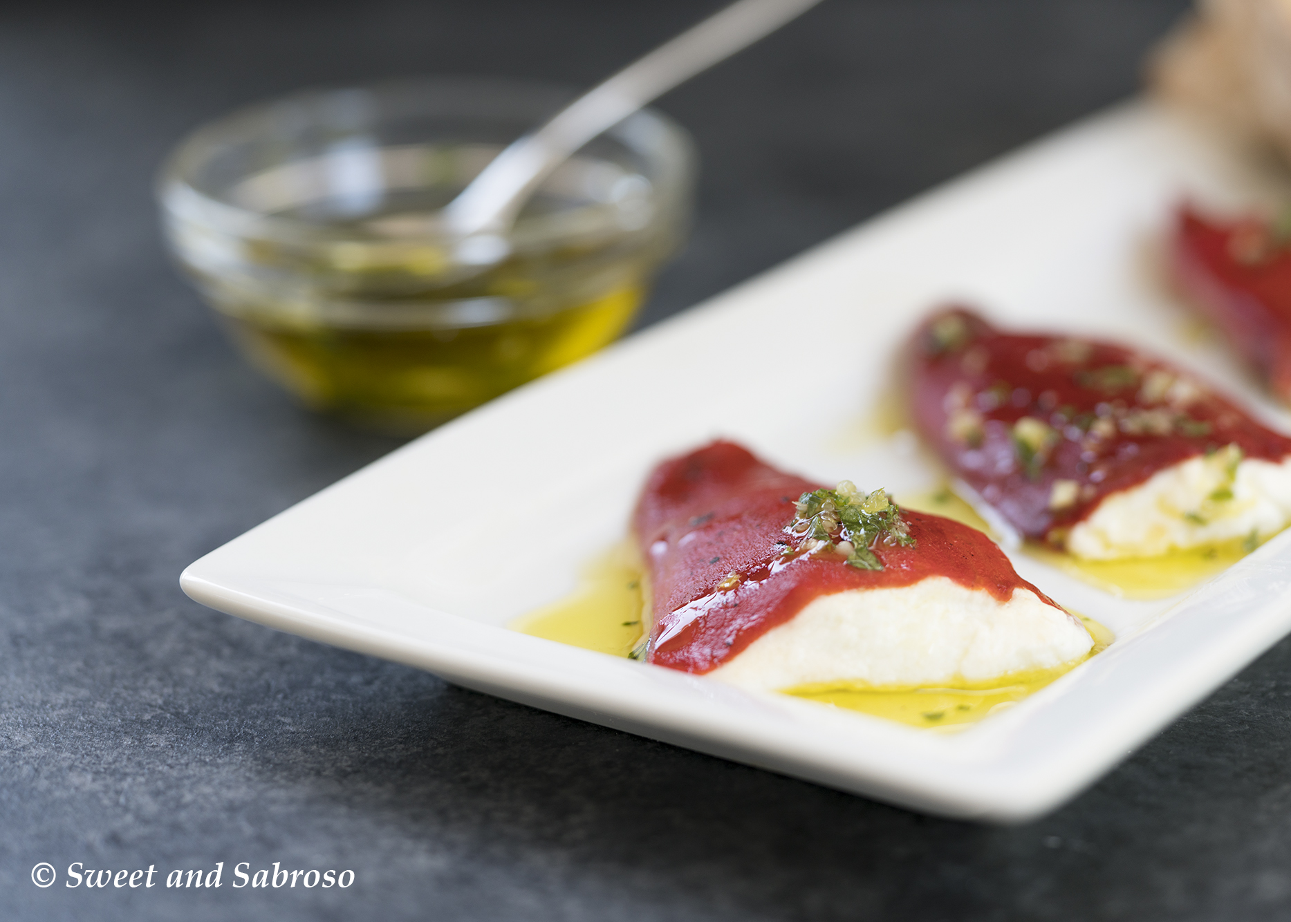 Goat Cheese Stuffed Piquillo Peppers (Pimientos de Piquillo) with Garlic Parsley Oil On a Platter